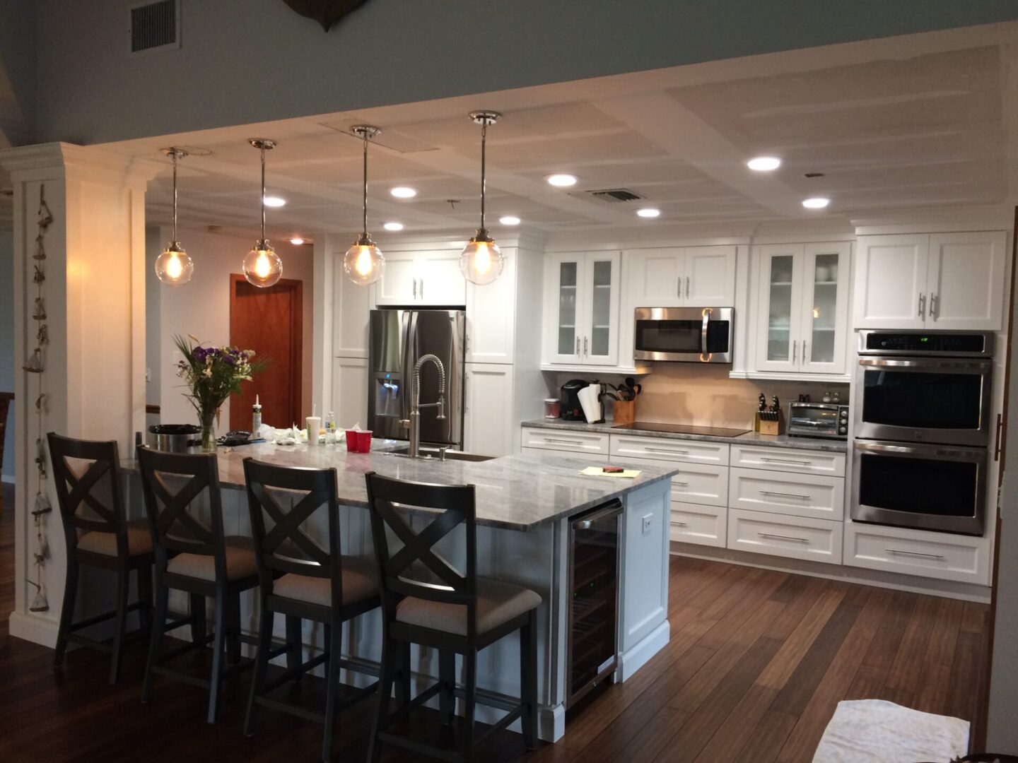 Modern kitchen with white cabinets and a large island with bar stools.